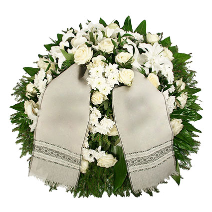 Flowers. Funeral wreath with white roses, white lilies, white chrysanthemums and decorative foliage.
Wreath with a ribbon